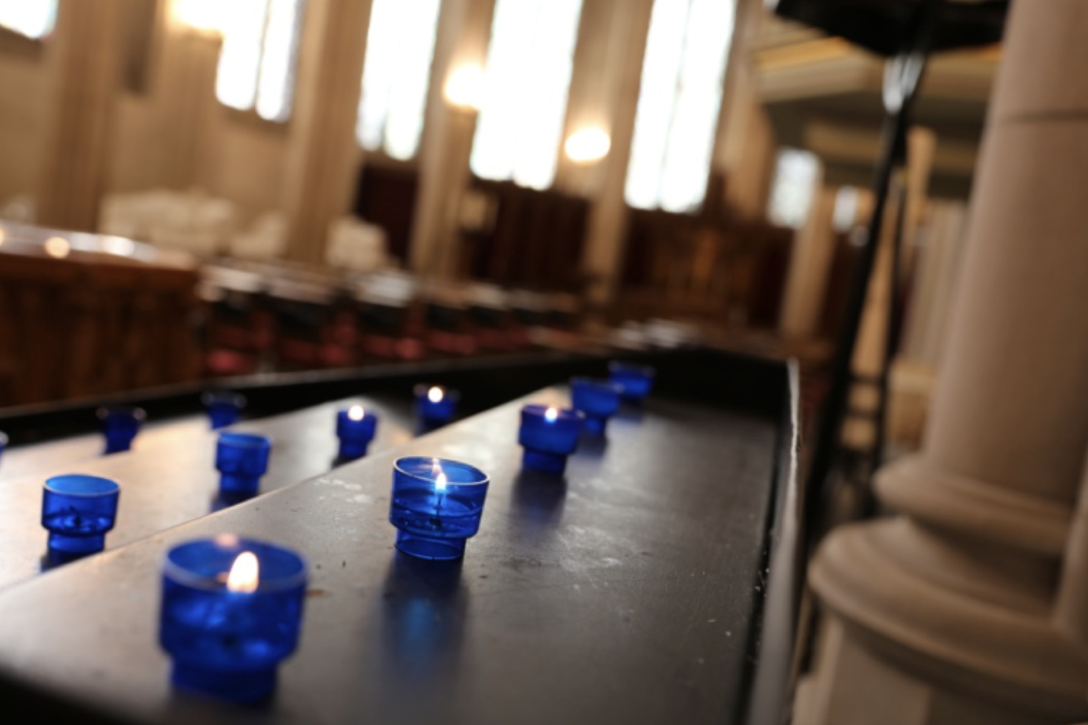 Photo of votive candles in church